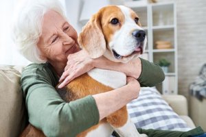 a woman celebrates her senior living amenities with her pet